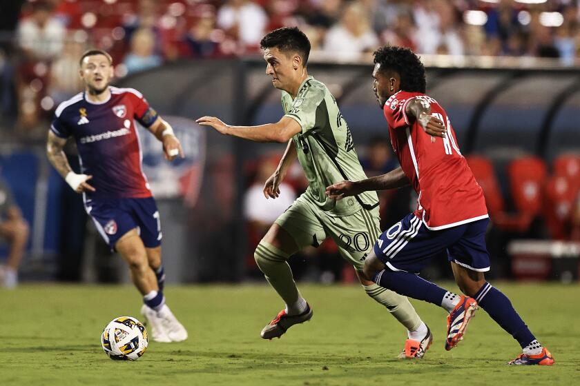 LAFC's Eduard Atuesta, center, controls the ball ahead of Houston's Jesus Ferreira.