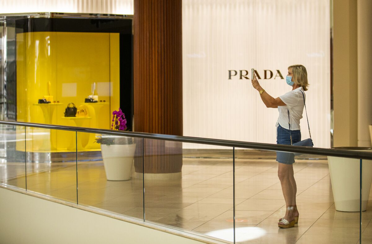 Leslee Effler of Irvine takes pictures of the Jewel Court in South Coast Plaza.