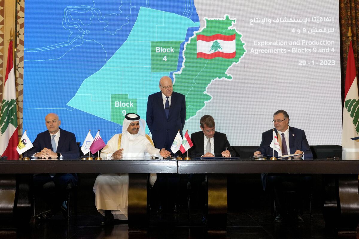 From left, Claudio Descalzi, the CEO of Italy's state-run energy company, ENI, Qatar's Minister of State for Energy Affairs Saad Sherida al-Kaabi, Lebanese caretaker Prime Minister Najib Mikati, Lebanese caretaker Energy Minister Walid Fayad and TotalEnergies CEO Patrick Pouyanne sign an agreement in Beirut, Lebanon, Sunday, Jan. 29, 2023. Lebanon, two international oil giants and state-owned oil and gas company Qatar Energy agreed Sunday that the Qatari firm will join a consortium that will search for gas in the Mediterranean Sea off Lebanon's coast. (AP Photo/Bilal Hussein)