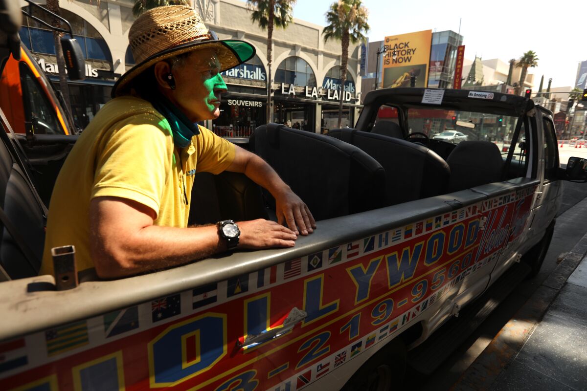 Marty Minogue, 63, manager of Hollywood Value Tours, sits in an empty car that he used to give tours on Hollywood Boulevard.