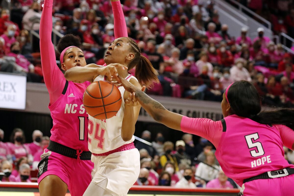 Georgia Tech's Eylia Love (24) has the ball tipped away by North Carolina State's Jada Boyd (5) with Jakia Brown-Turner (11) nearby during the first half of an NCAA college basketball game, Monday, Feb. 7, 2022, in Raleigh, N.C. (AP Photo/Karl B. DeBlaker)