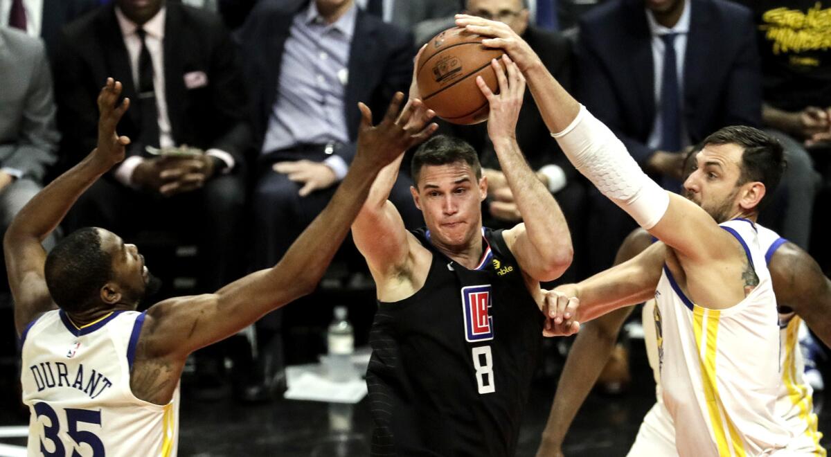 Clippers forward Danilo Gallinari (8) is forced to pass after getting trapped by Warriors forward Kevin Durant, left, and center Andrew Bogut during Game 3.