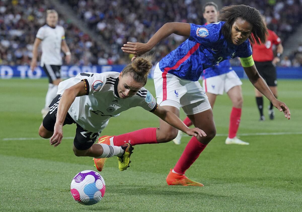 Germany's Lina Magull is challenged by France's Wendie Renard for the ball.