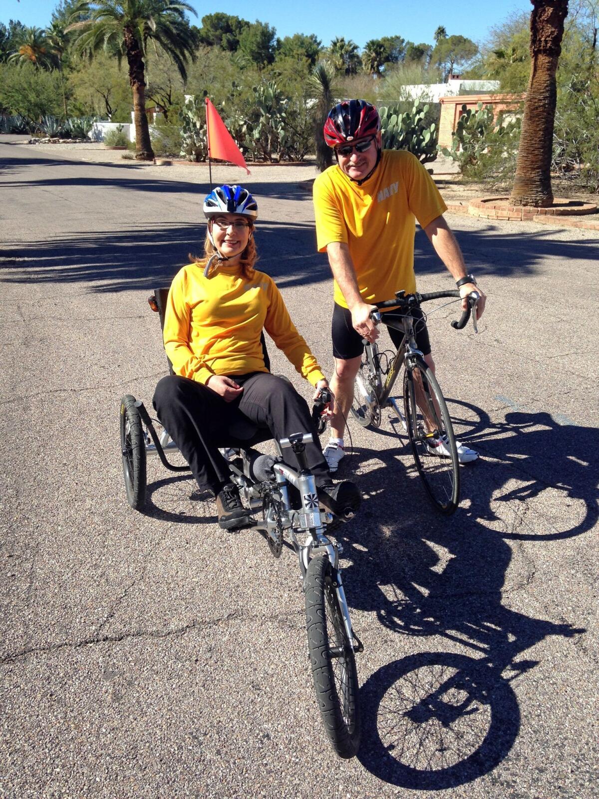 Former congresswoman Gabrielle Giffords and her husband, Mark Kelly, pause while training for a 40-mile charity ride called El Tour de Tucson, held Saturday.