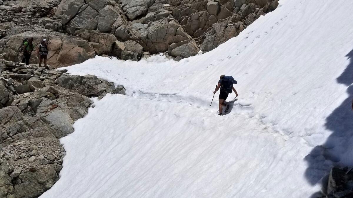 Wesley Tils crosses a snow-covered trail near Kings Canyon National Park in June.