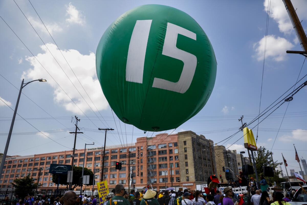 Workers march through downtown Los Angeles on April 14 to demand a nationwide $15-an-hour minimum wage.