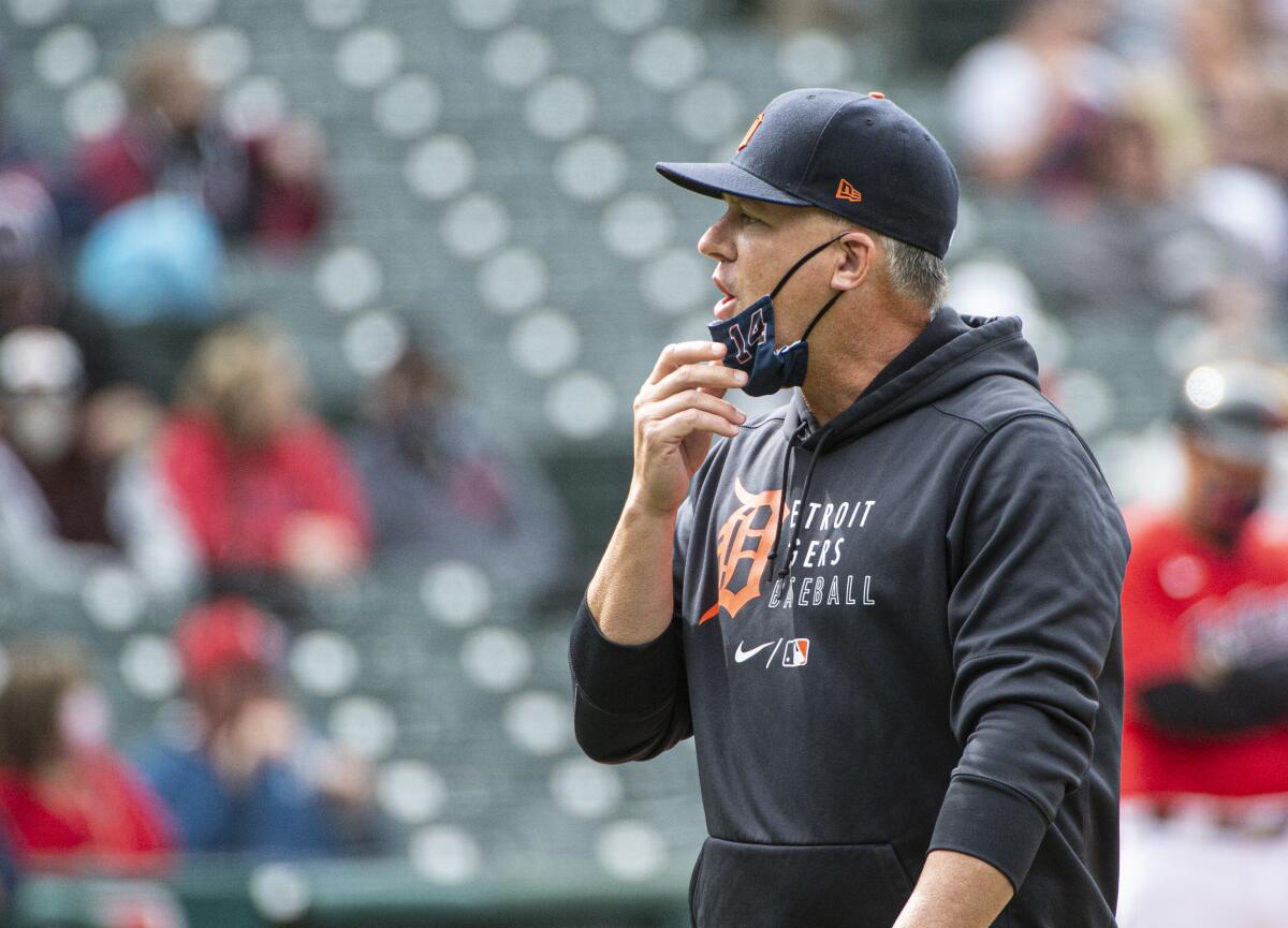 Detroit Tigers manager A.J. Hinch walks back to the dugout after making a pitching change during the eighth inning of a baseball game against the Cleveland Indians in Cleveland, Sunday, April 11, 2021. (AP Photo/Phil Long)