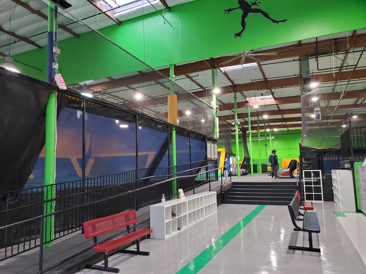 The interior of an indoor trampoline park in a warehouse building