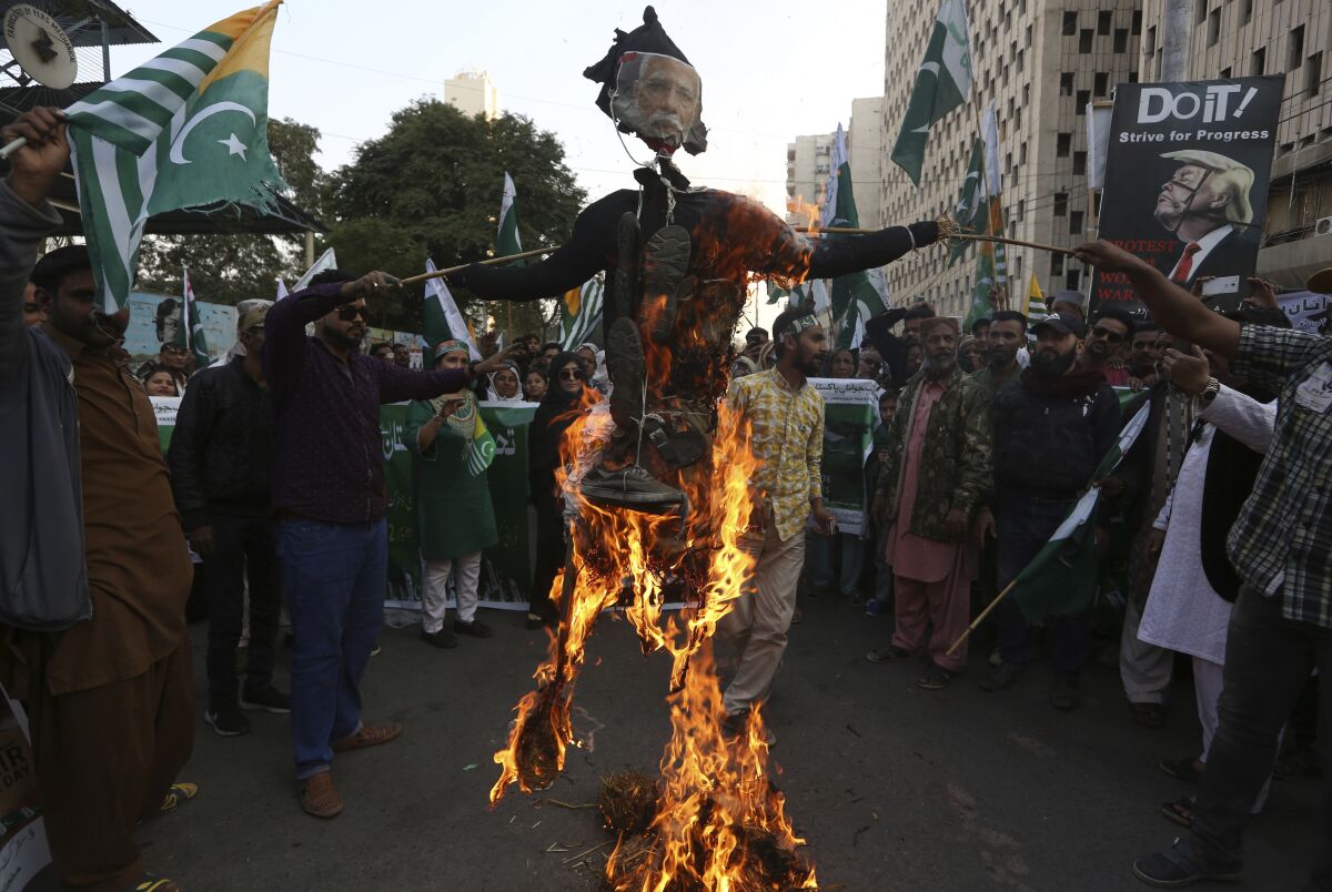 FILE - In this Feb. 5, 2020, file photo, protesters burn an effigy of Indian prime minister during a rally to express solidarity with Indian Kashmiris struggling for their independence, in Karachi, Pakistan. India's leaders are anxiously watching the Taliban takeover in Afghanistan, fearing that it will benefit their bitter rival Pakistan and feed a long-simmering insurgency in the disputed region of Kashmir, where militants already have a foothold. (AP Photo/Fareed Khan, File)