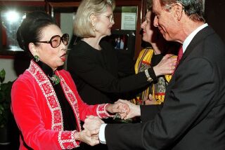 Billed as the Last Supper by Madame Sylvia Wu, this was the closing night party, Wednesday, February 11, 1998 for her long-time restaurant Madame Wu's Garden. Photo of Madame Sylvia Wu greeting Govenor Pete Wilson at the door. (LOS ANGELES TIMES PHOTO BY KEN HIVELY) Photo/Art by:Ken Hively