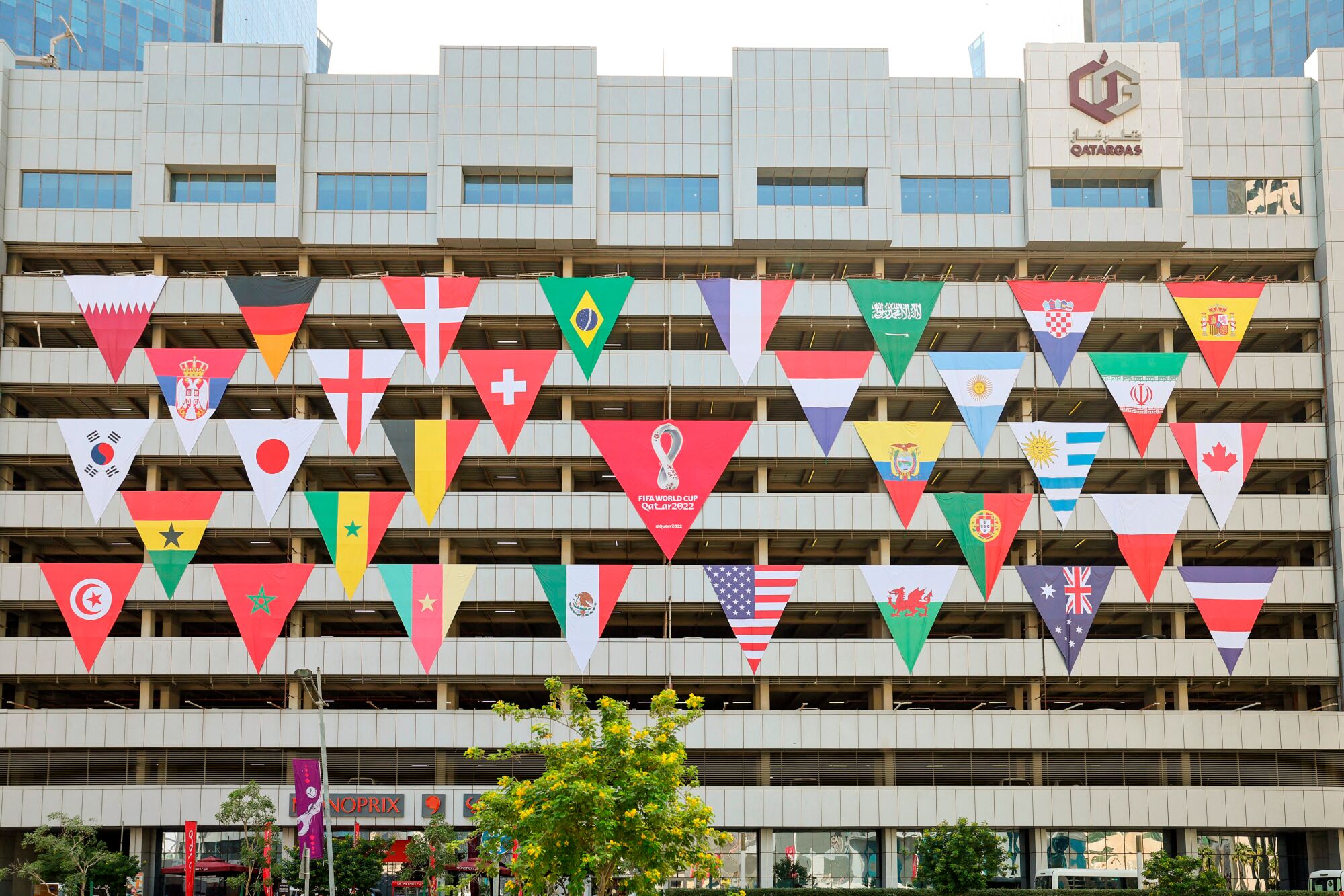 A building decorate with the flags of the teams participating in the 2022 FIFA World Cup in the Qatari capital Doha.