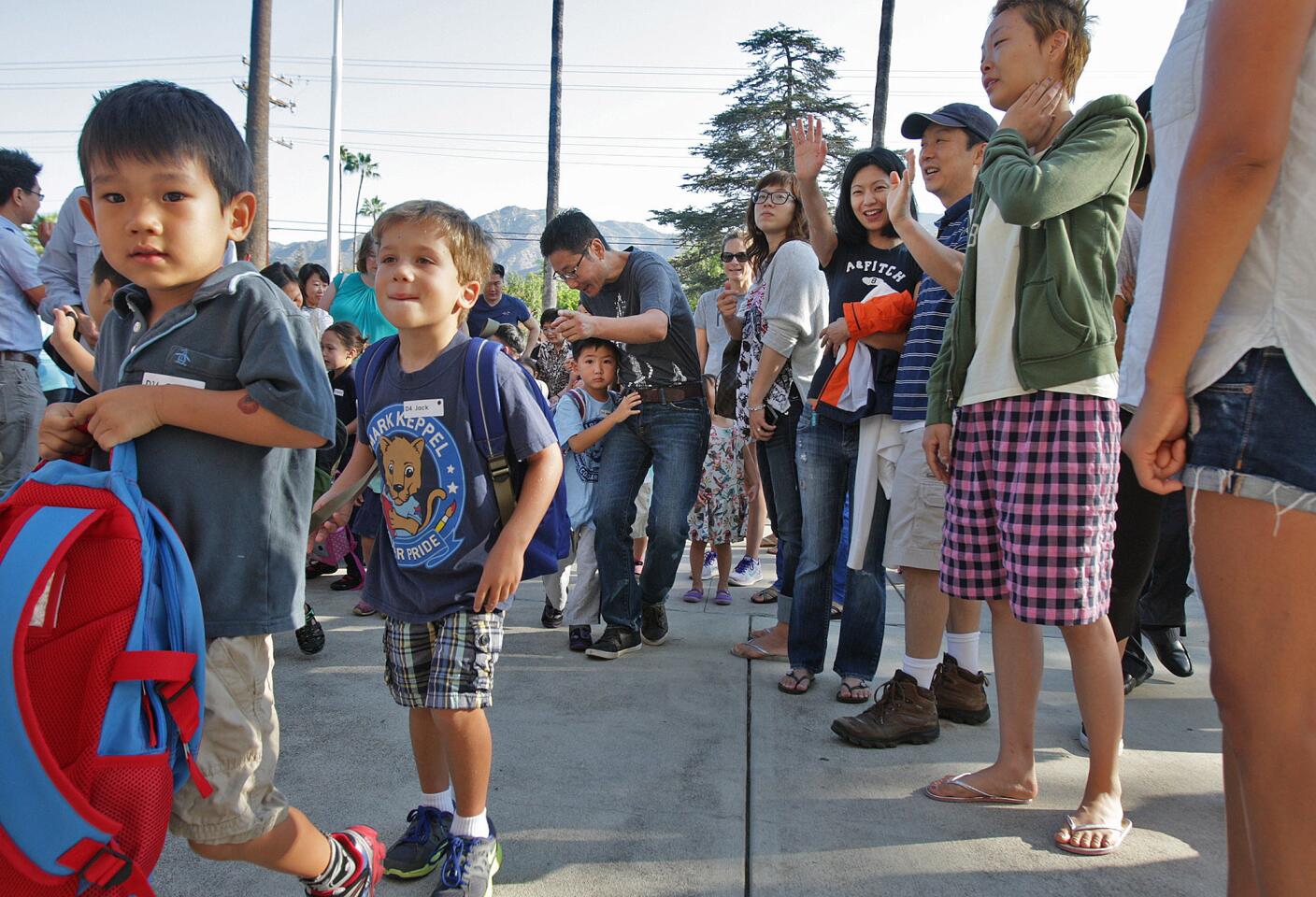 Mrs. Youn's Kindergarten class, after gathering in front of the school in a corral created by all of their eager happy parents, are told to start walking to their class at Mark Keppel Visual and Performing Arts Magnet School in Glendale on the first day of school on Monday, August 11, 2014.