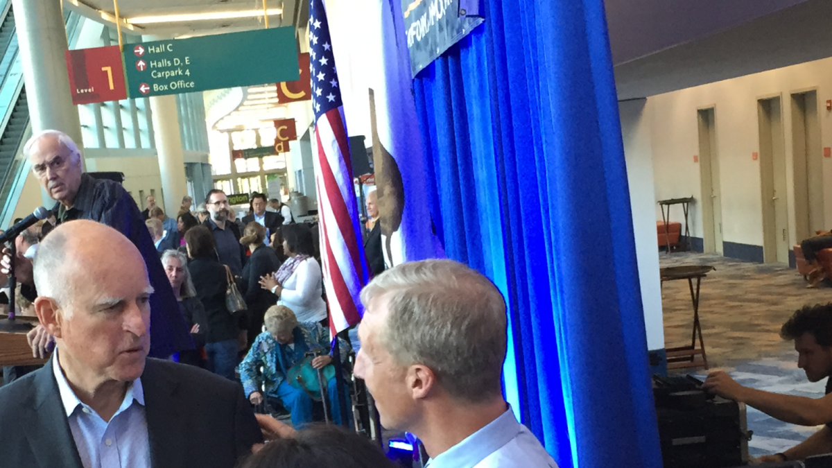 Gov. Jerry Brown speaks Friday with San Francisco billionaire and environmentalist Tom Steyer at the state Democratic convention in Anaheim. Behind Brown is state Democratic chairman John Burton.