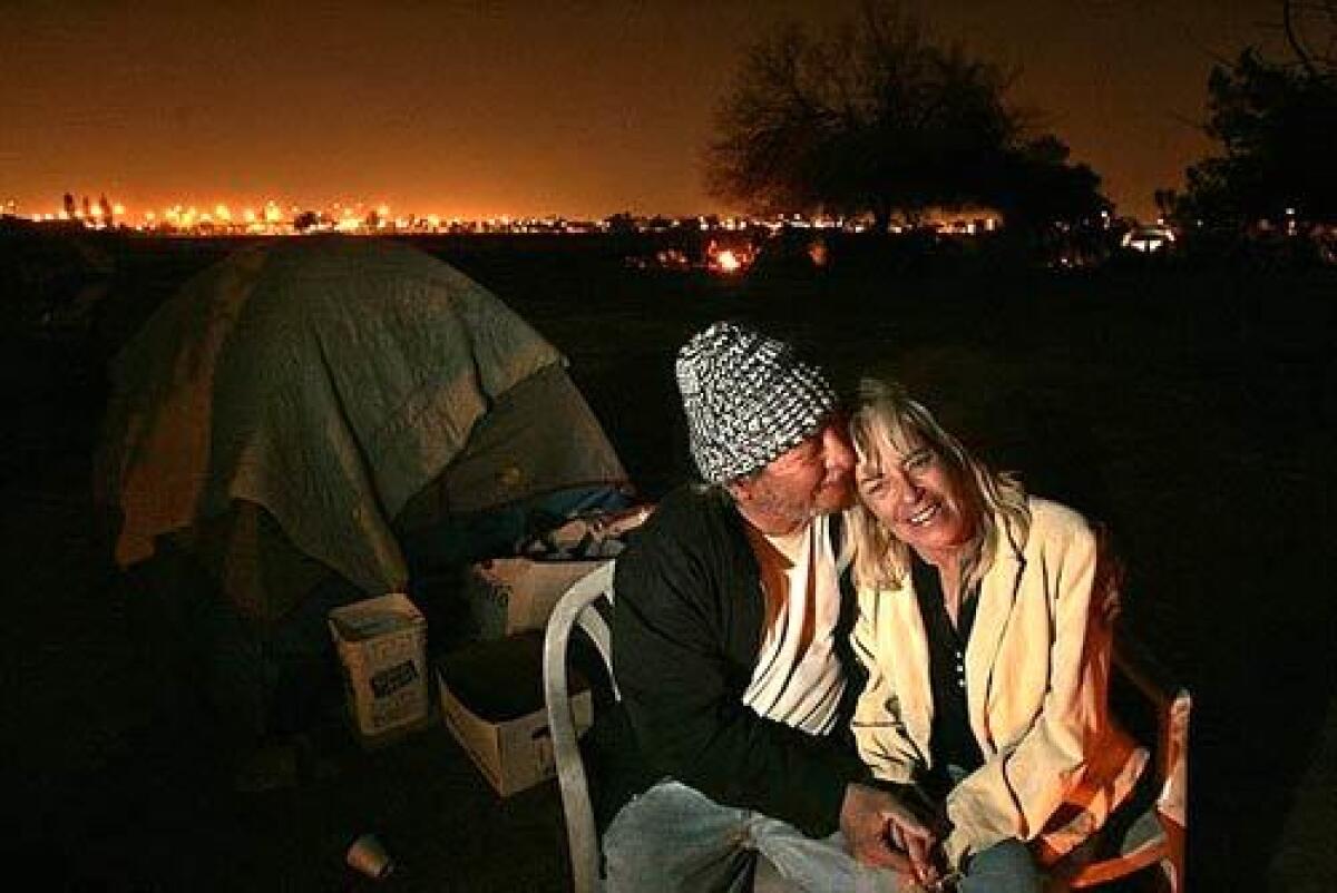 A chilly night and a bonfire provide a close moment for Jim Martinez and Teresa Dodson, who are both 54. I hate it here. I want a house, I want a life, Dodson says. Ive never been in this position before in my entire life.