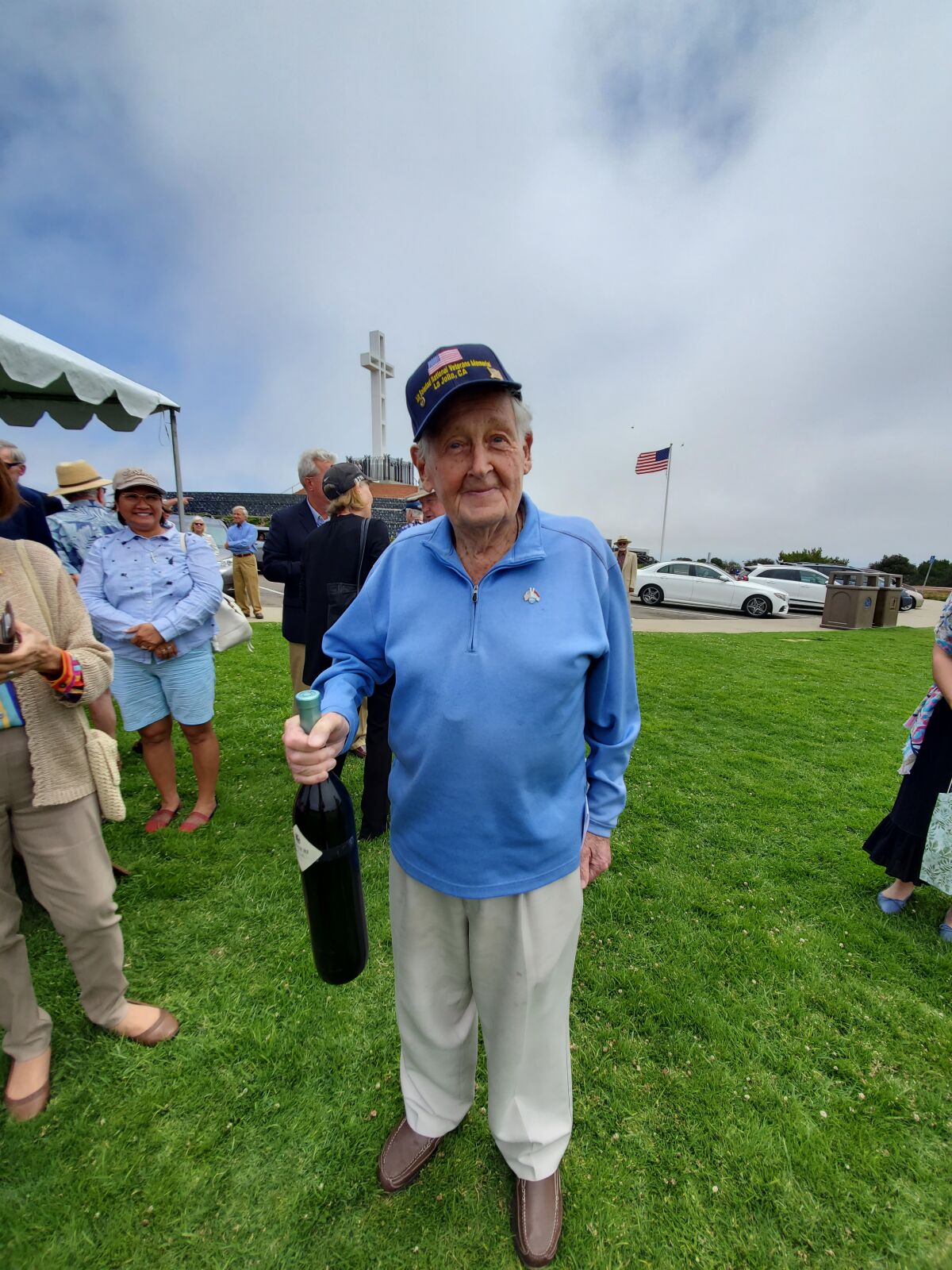 Max Gurney holds a gift bottle of wine at a celebration of his 100th birthday on June 30 atop Mount Soledad.