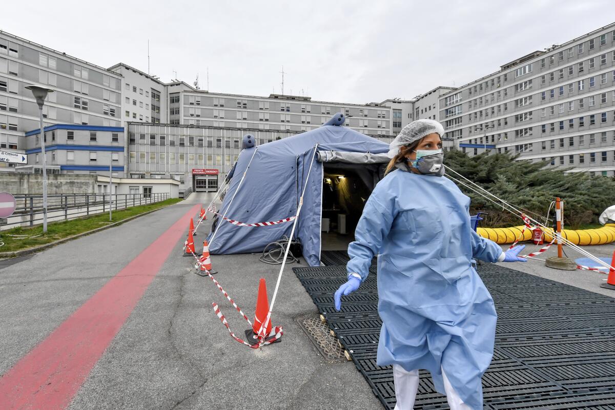 A paramedic walks out of a tent that was set up in front of the emergency ward of the Cremona hospital in northern Italy on Feb. 20.