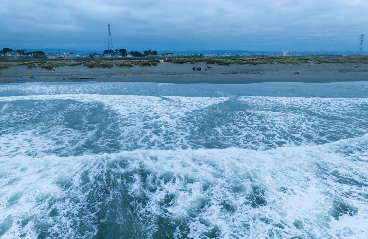 A beach campfire provides warmth at sunset on the Samoa Peninsula in Eureka