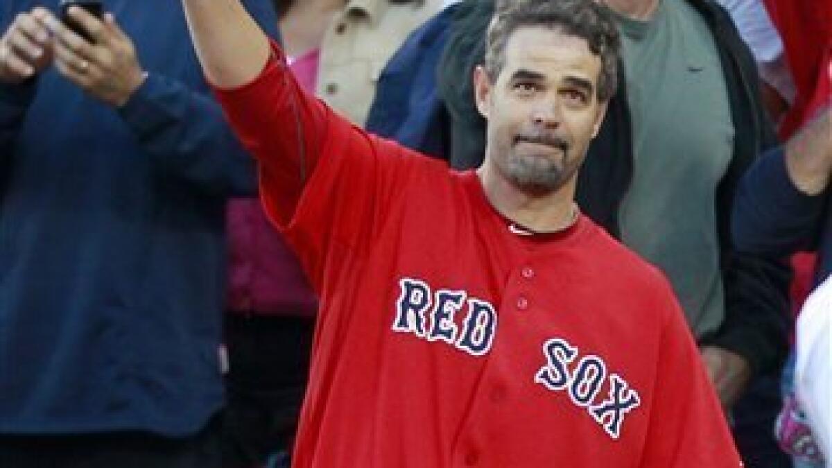 Boston Red Sox's Mike Lowell, right, is joined on the field by his family,  from left, wife Bertica, daughter Alexis and son Anthony during a ceremony  to honor his announced retirement before