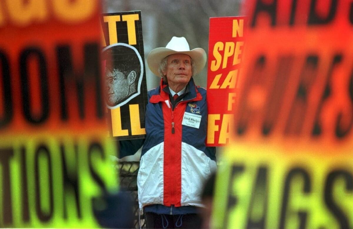 Fred Phelps, founder of the Westboro Baptist Church, stands in 1999 outside the courthouse in Laramie, Wyo., during the trial over the killing of Matthew Shepard.