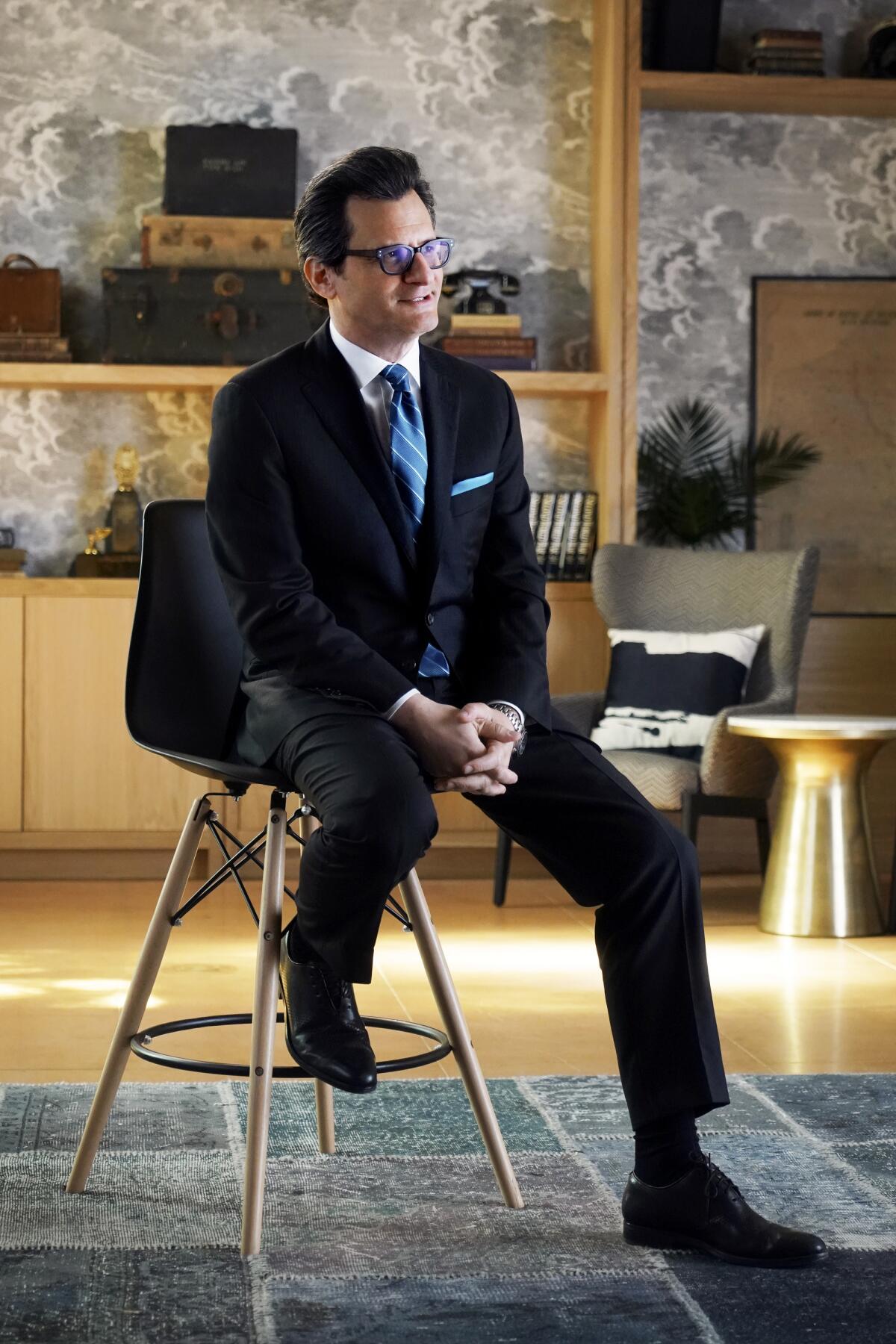 TCM host Ben Mankiewicz sits on a stool.