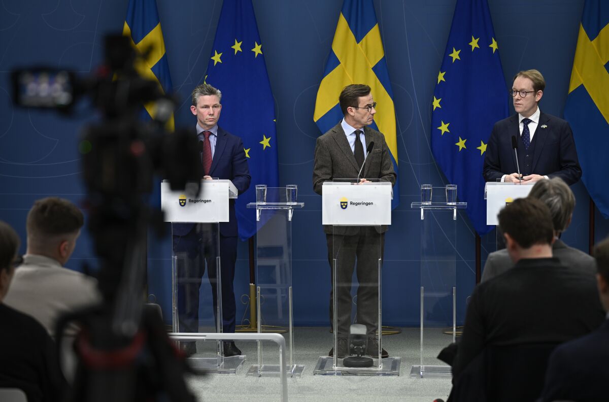 From left, Sweden's Defense Minister Pal Jonson, Prime Minister Ulf Kristersson and Foreign Minister Tobias Billstrom attend a news conference on Sweden's NATO bid in Stockholm, Sweden, Tuesday Jan. 24, 2023. On Monday, Turkish President Recep Tayyip Erdogan warned Sweden again not to expect support for its application following weekend protests in Stockholm by an anti-Islam activist and pro-Kurdish groups. (Pontus Lundahl/TT News Agency via AP)