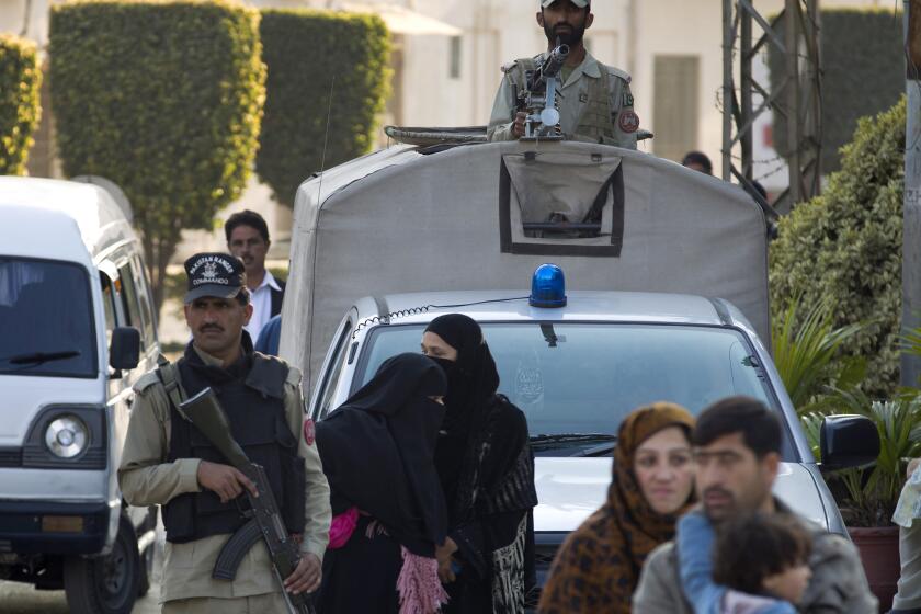 Pakistani paramilitary soldiers keep watch Tuesday outside the Armed Forces Institute of Cardiology in Rawalpindi, where former president and military ruler Pervez Musharraf was admitted.