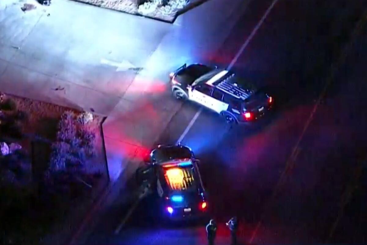 Overhead view of two patrol cars and two officers.