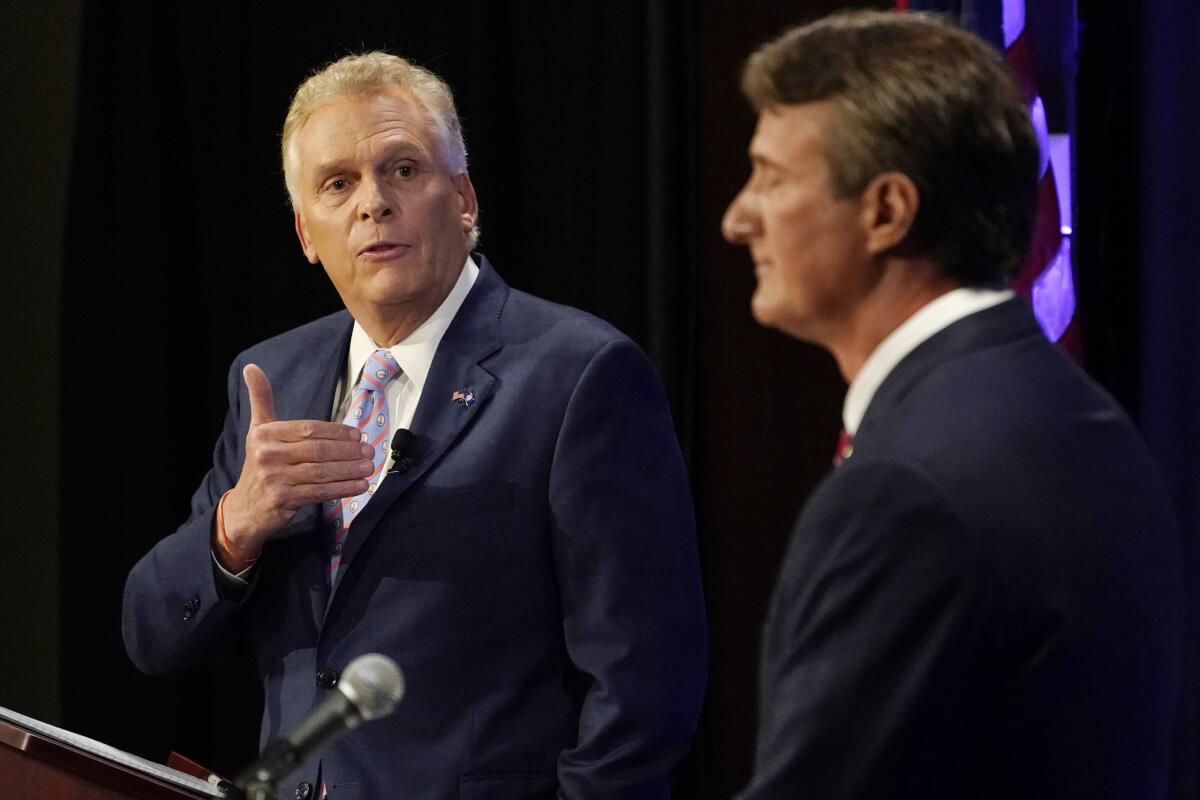 Democratic gubernatorial candidate former Governor Terry McAuliffe, left, gestures as Republican challenger, Glenn Youngkin, listens during a debate at the Appalachian School of Law in Grundy, Va., Thursday, Sept. 16, 2021. (AP Photo/Steve Helber)