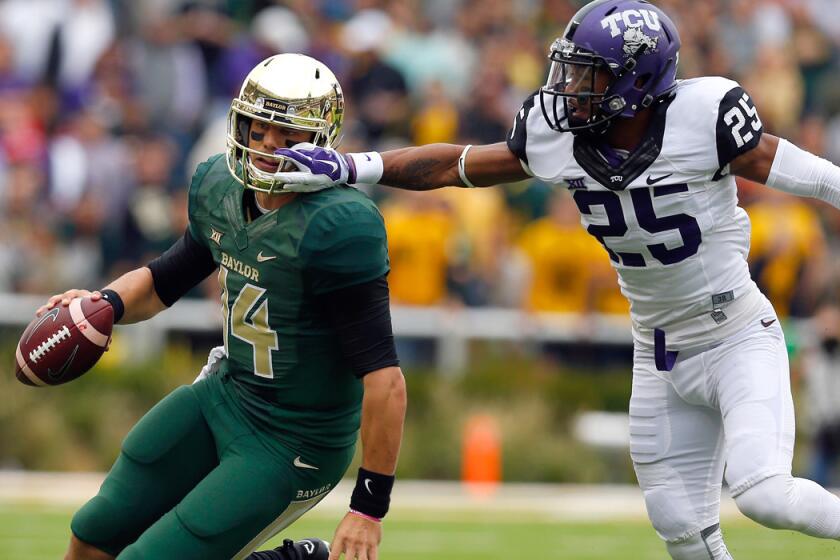 Baylor quarterback Bryce Petty tries to evade Texas Christian cornerback Kevin White on a scramble in the first half Saturday.