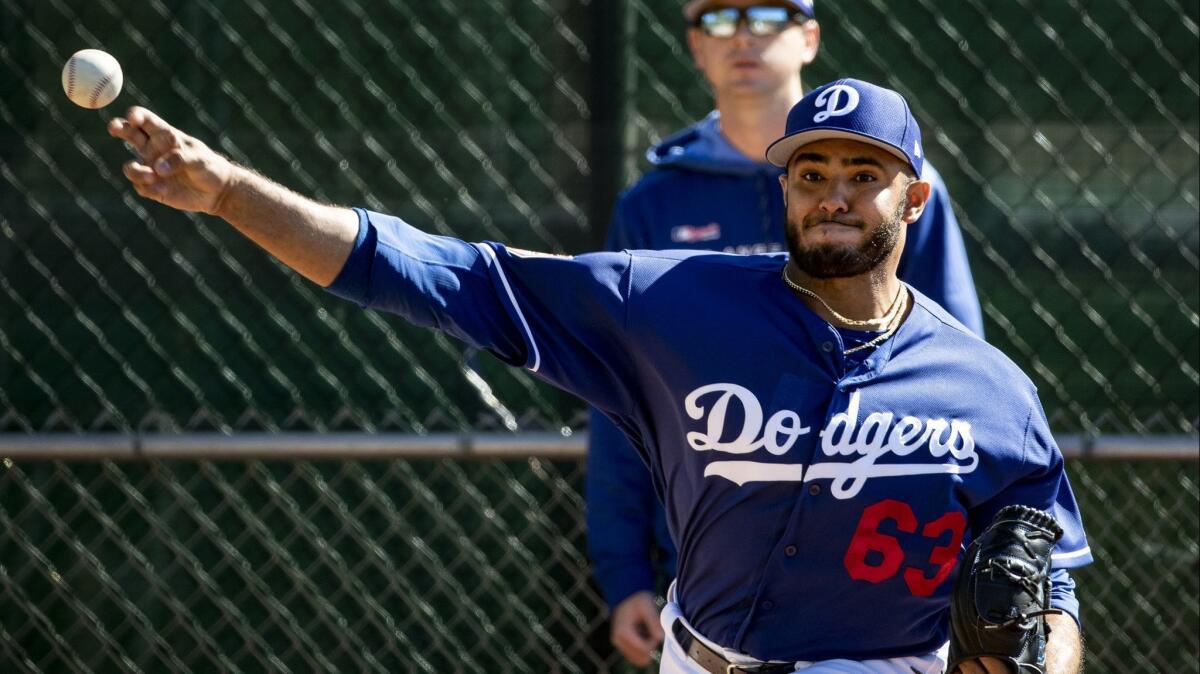 Dodgers relief pitcher Yimi Garcia warms up during a spring training practice session on Feb. 19.