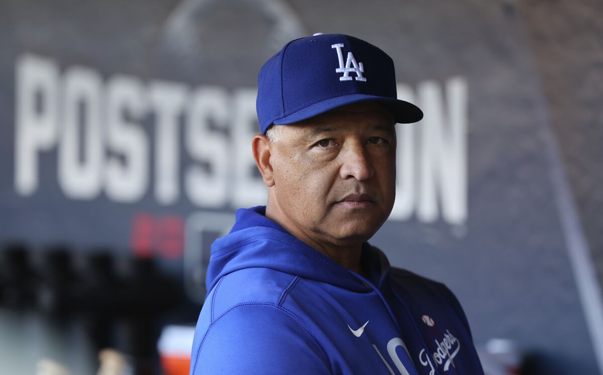 Dodgers manager Dave Roberts stands in the dugout before Game 5 of the NLDS on Oct. 14, 2021.