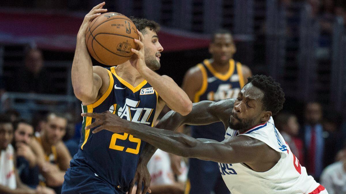 Clippers guard Patrick Beverley, right, defends Utah Jazz guard Raul Neto during the second half on Tuesday.