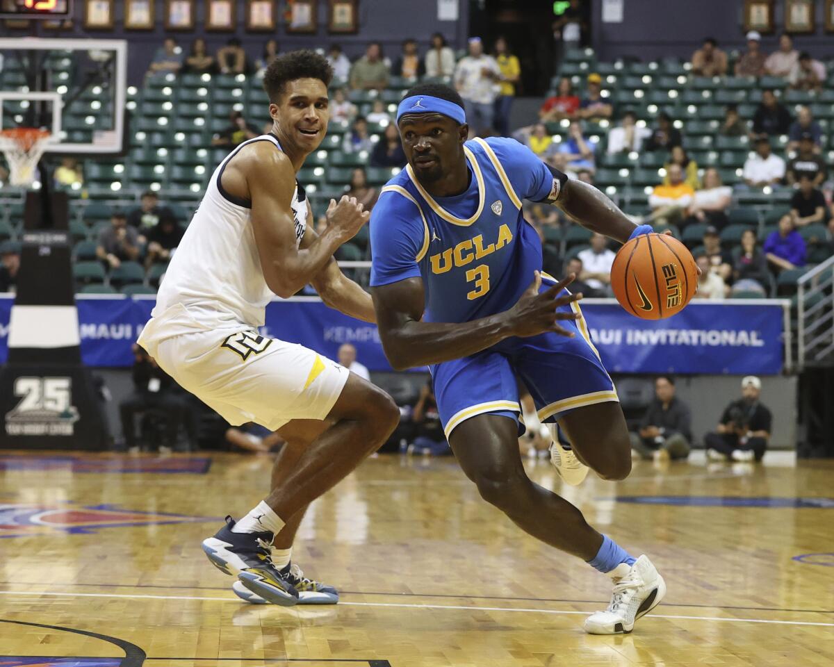 Adem Bona gets past Marquette's Oso Ighodaro. 