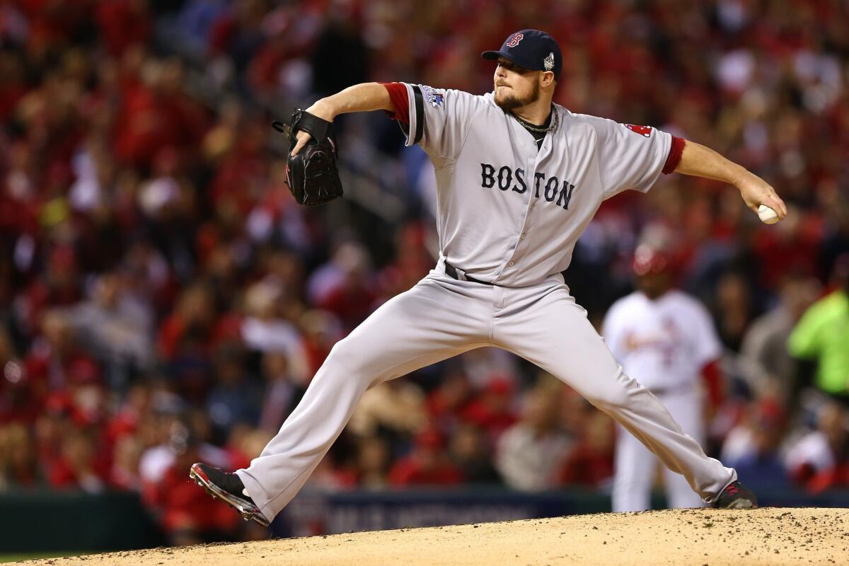 Boston Red Sox starter Jon Lester delivers a pitch during a 3-1 win over the St. Louis Cardinals in Game 5 of the World Series on Monday.