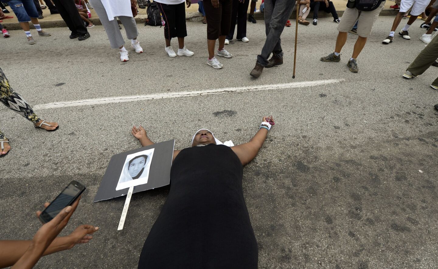 Barbara Dunn lies in the street while participating in the rally in front of the Richard B. Russell Federal Building in Atlanta.