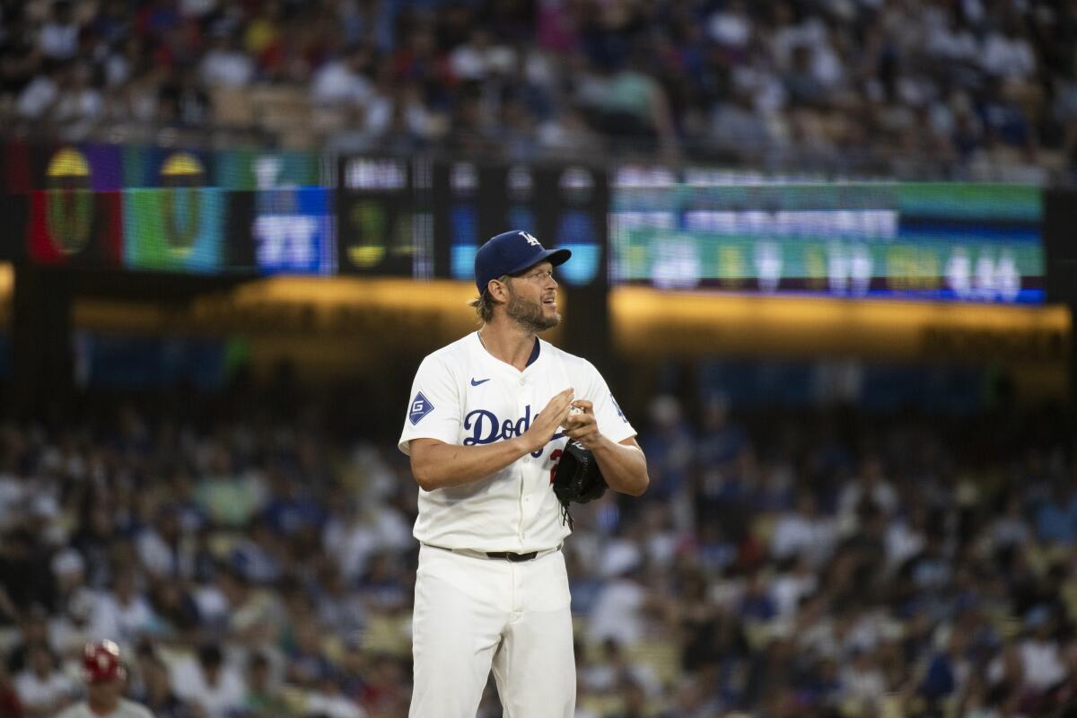 Dodgers pitcher Clayton Kershaw rubs the ball during a game against the Phillies at Dodger Stadium on Tuesday.