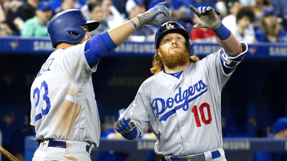 Dodgers third baseman Justin Turner (10) and first baseman Adrian Gonzalez celebrate with a 'selfie' after Turner hit a home run against the Blue Jays in the eighth inning May 7.