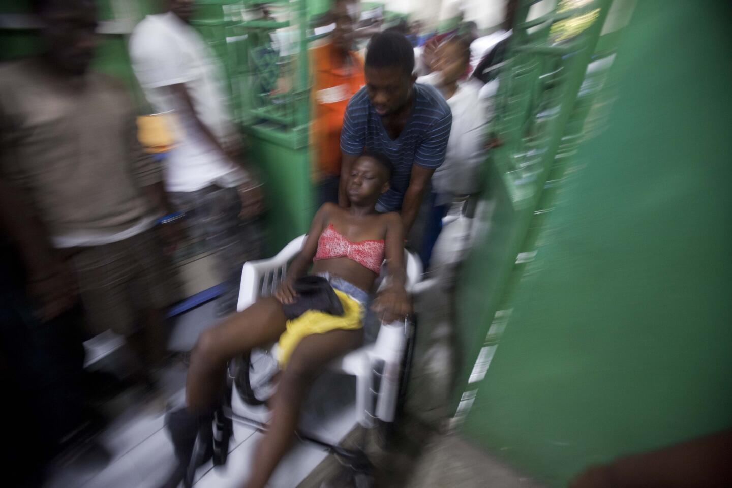 A reveler who was injured during carnival celebrations waits for treatment at the emergency room of the General Hospital in Port-au-Prince, Haiti, on Feb. 17.