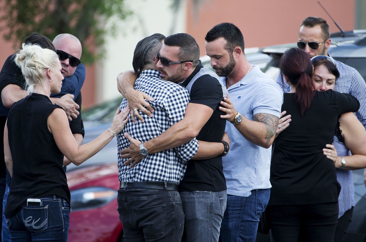 Mourners embrace outside the visitation for Pulse nightclub shooting victim Javier Jorge-Reyes.
