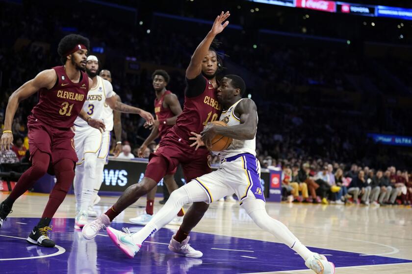 Los Angeles Lakers guard Kendrick Nunn, right, drives to the basket while Cleveland Cavaliers guard Darius Garland (10) defends during the first half of an NBA basketball game Sunday, Nov. 6, 2022, in Los Angeles. (AP Photo/Marcio Jose Sanchez)