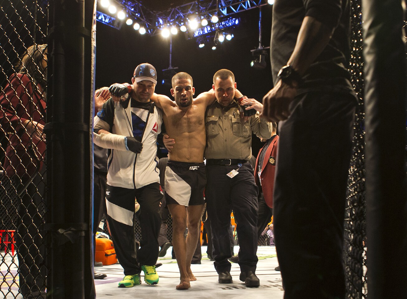 Featherweight Noad Lahat is assisted from the octagon by medical personnel after being knocked out by Diego Rivas during UFC Fight Night 82 at the MGM Grand Garden Arena in Las Vegas on Saturday, February 6 2016. (L.E. Baskow/Las Vegas Sun via AP) LAS VEGAS REVIEW-JOURNAL;MANDATORY CREDITS