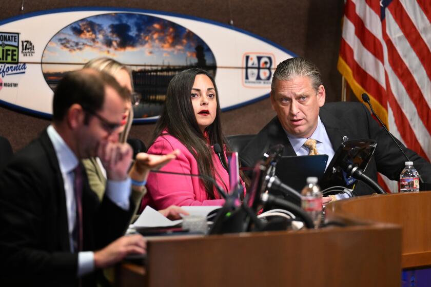 Huntington Beach, California October 17, 2023-Mayor Pro Tem Gracie Van Der Mark and mayor Tony Strickland listen to a speaker during a Huntington Beach City Council meeting Tuesday night. (Wally Skalij/Los Angeles Times)