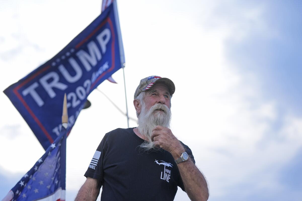 Supporter of former President Donald Trump, Mark Harvey, demonstrates near Trump's Mar-a-Lago estate, Thursday, May 30, 2024, in Palm Beach, Fla. Trump became the first former president to be convicted of felony crimes as a New York jury found him guilty of all 34 charges in a scheme to illegally influence the 2016 election through a hush money payment to a porn actor who said the two had sex. (AP Photo/Wilfredo Lee)