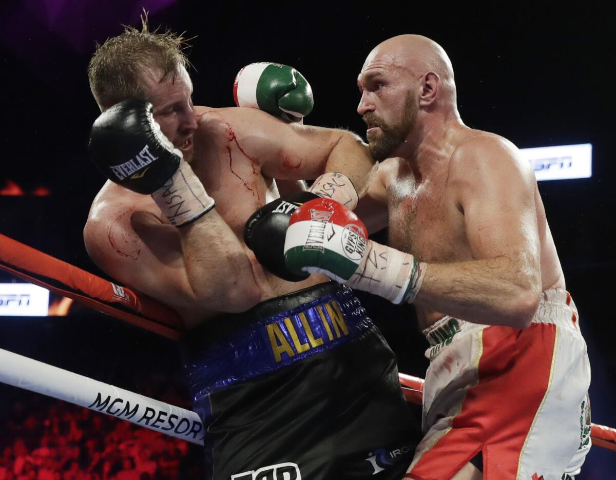 Tyson Fury, right, punches Otto Wallin during their heavyweight boxing match Saturday.