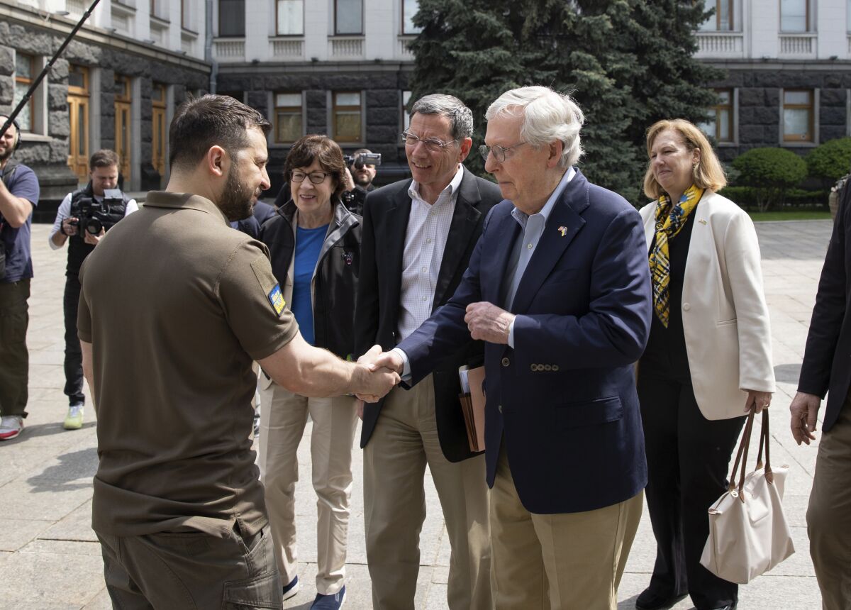 In this handout photo provided by the Ukrainian Presidential Press Office, Ukrainian President Volodymyr Zelenskyy, left, shakes hands with Senate Minority Leader Mitch McConnell, R-Ky., in Kyiv, Ukraine, Saturday, May 14, 2022. (Ukrainian Presidential Press Office via AP)
