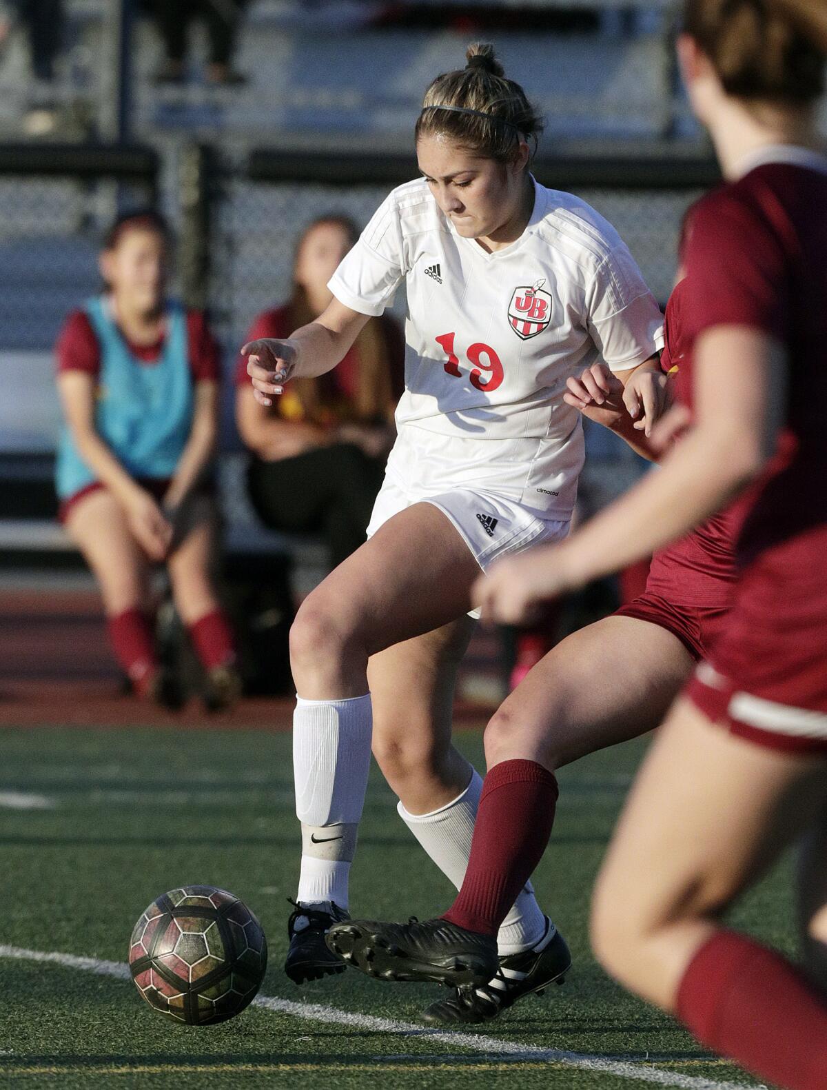 Burroughs' Stephanie Torres battles for control of the ball against Arcadia in a Pacific League girls' soccer game at Arcadia High School in Arcadia on Tuesday, January 28, 2020.