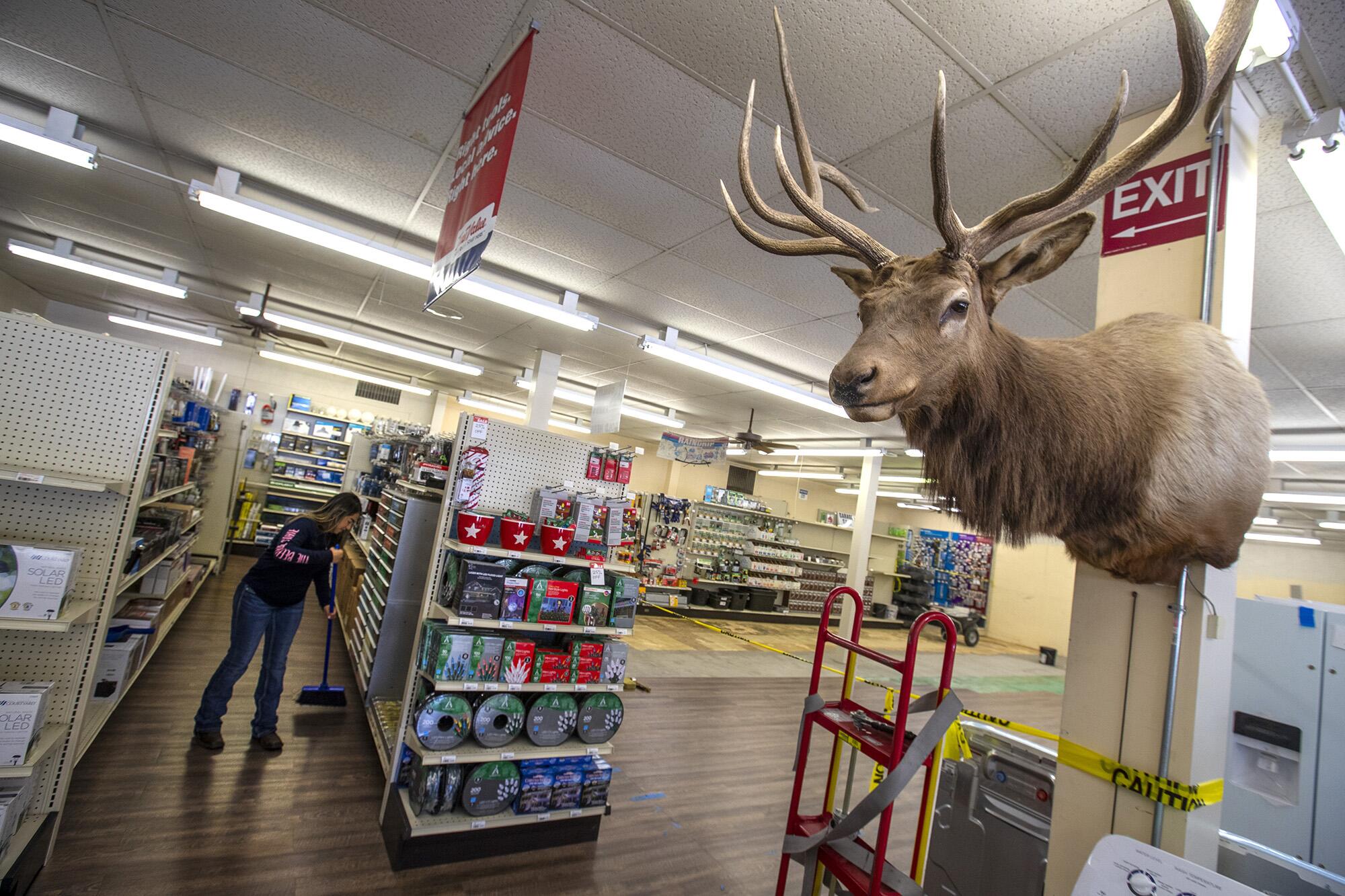 An employee sweeps up at Kevin Phillips' Mountain Mercantile hardware and auto parts store in Caliente, Nevada.