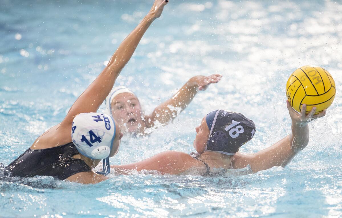 Newport Harbor's Olivia Giolas (18) is defended by Corona del Mar's Megan Peterson (14) in a Surf League match on Jan. 15, 2019.