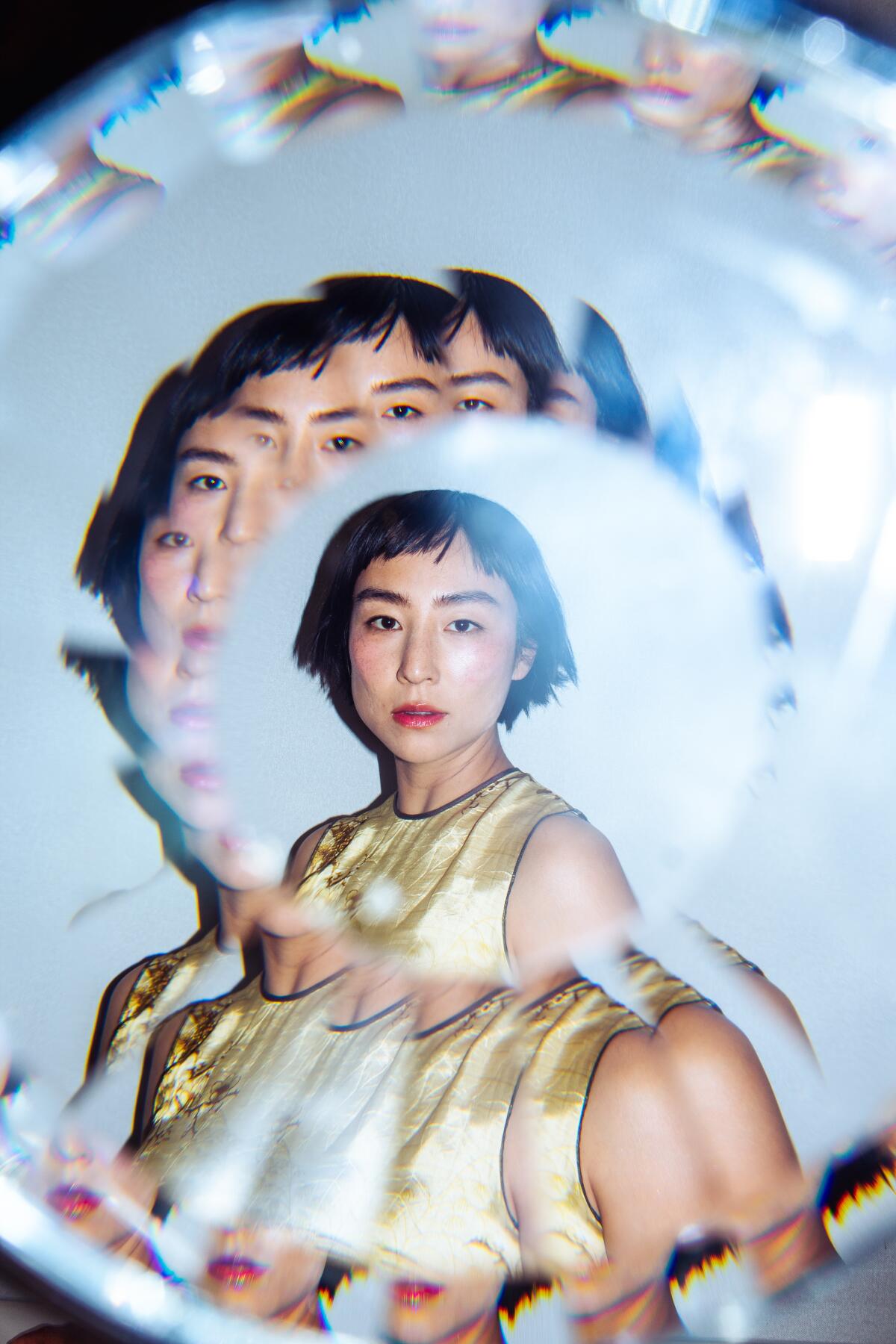 A portrait of a woman using a kaleidoscope-type filter.