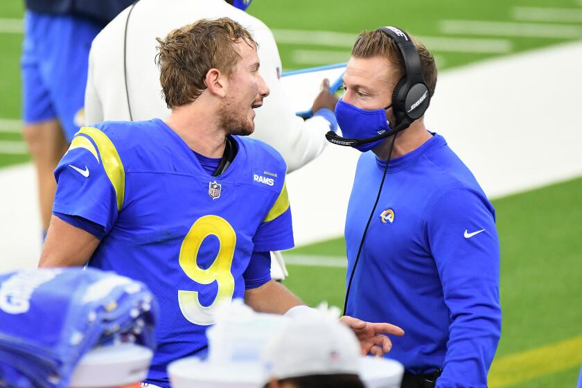 INGLEWOOD, CALIFORNIA JANUARY 3, 2021-Rams quarterback John Wolford talks with head coach Sean McVay.